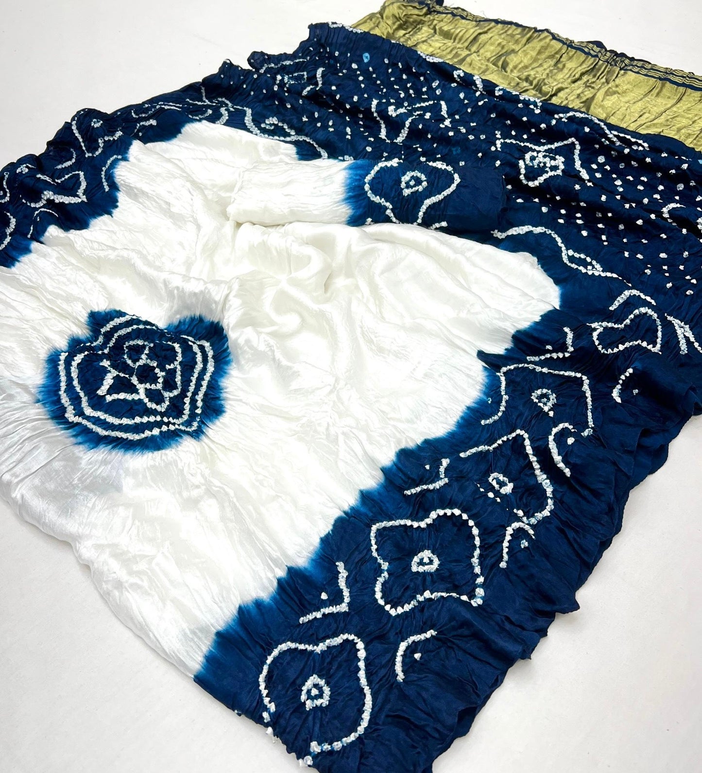 Luxurious Gajji silk saree adorned with vibrant contrast Bandhani patterns, ideal for festive and special occasions.