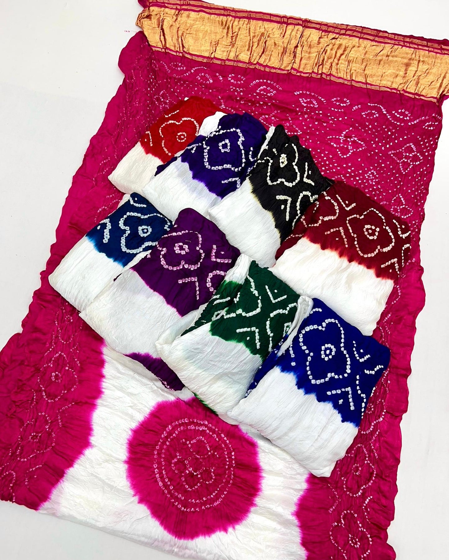 Luxurious Gajji silk saree adorned with vibrant contrast Bandhani patterns, ideal for festive and special occasions.