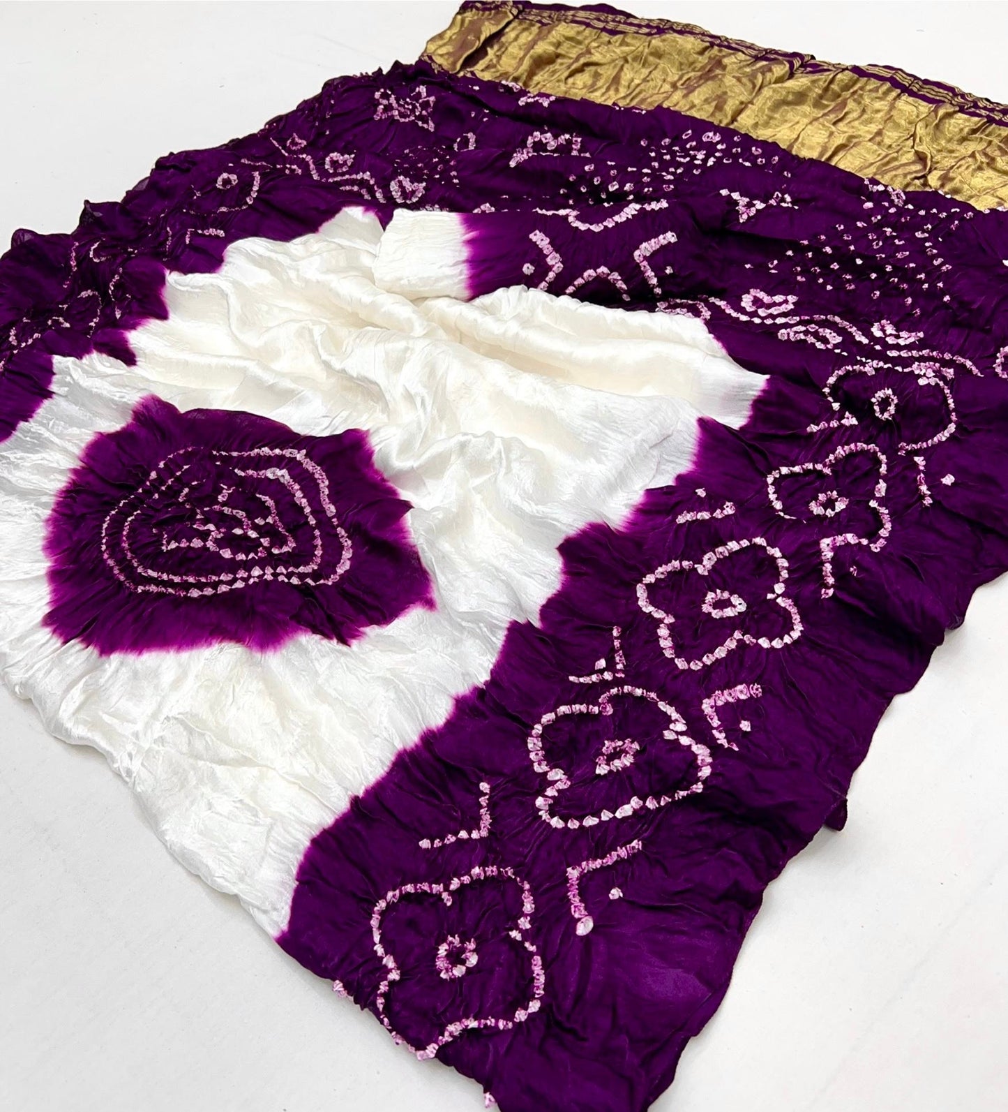 Luxurious Gajji silk saree adorned with vibrant contrast Bandhani patterns, ideal for festive and special occasions.