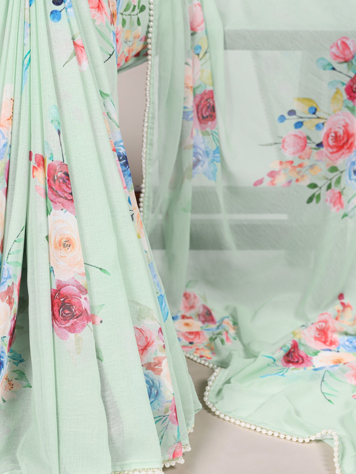 Premium weightless marble sarees crafted with soft, graceful floral prints, further enhanced by a delicate lace border
