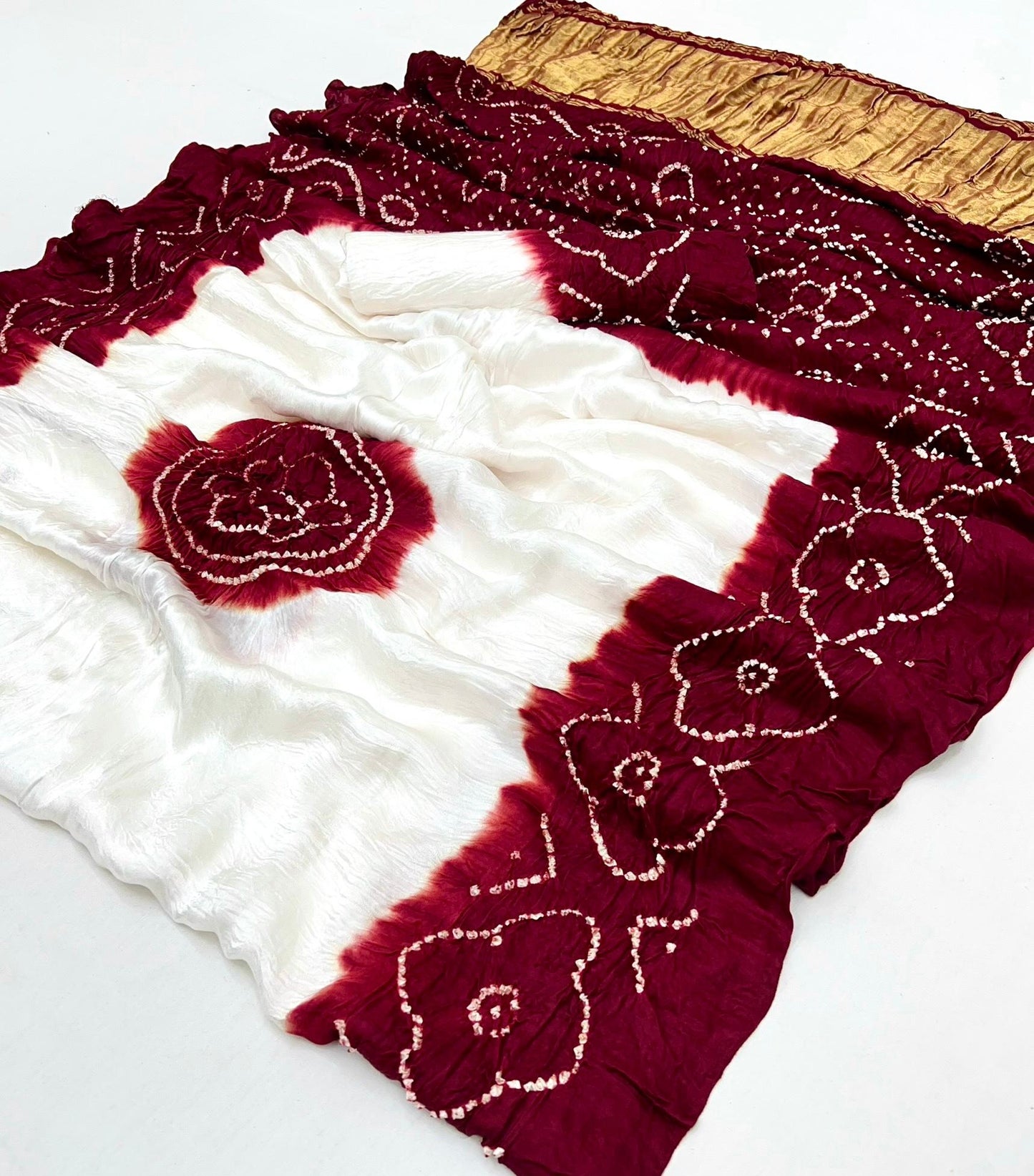 Luxurious Gajji silk saree adorned with vibrant contrast Bandhani patterns, ideal for festive and special occasions.