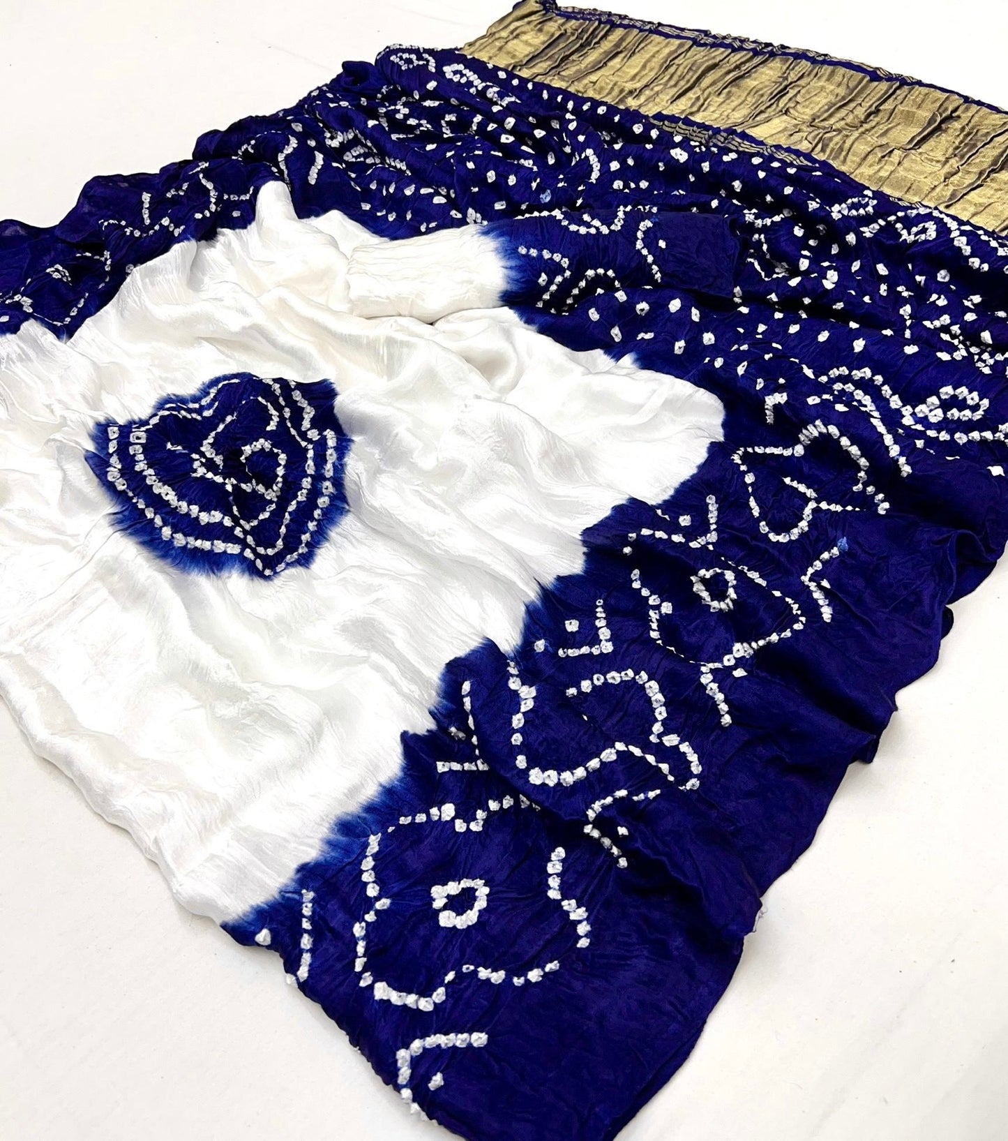 Luxurious Gajji silk saree adorned with vibrant contrast Bandhani patterns, ideal for festive and special occasions.